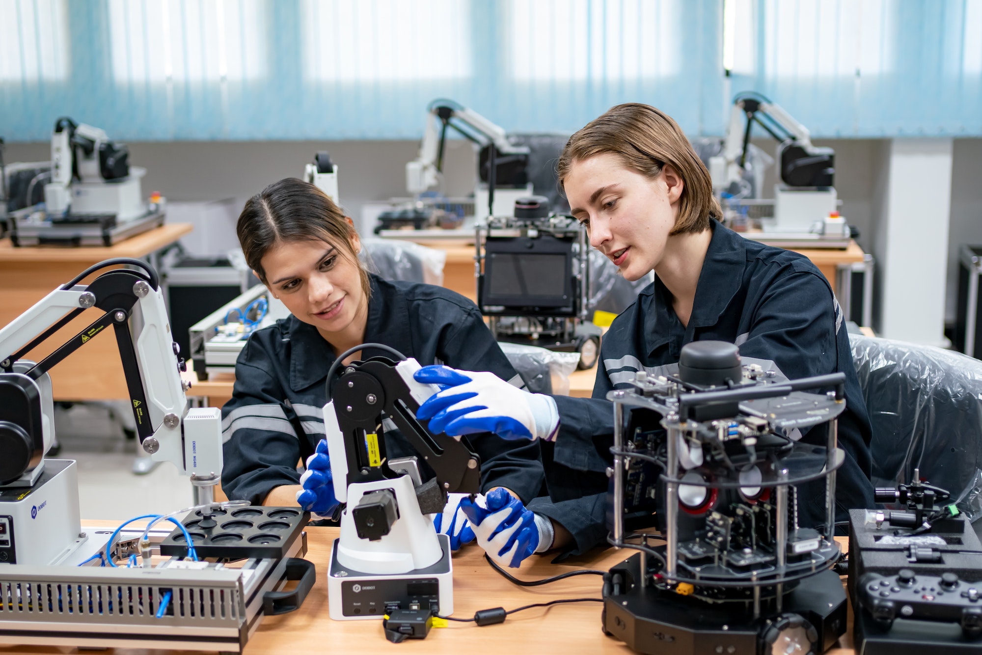 female-engineer-man-working-at-industrial-robot-in-factory-industrial-robotic-and-manufacturing.jpg